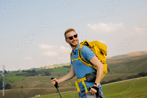 Young man enjoys hiking on a sunny day