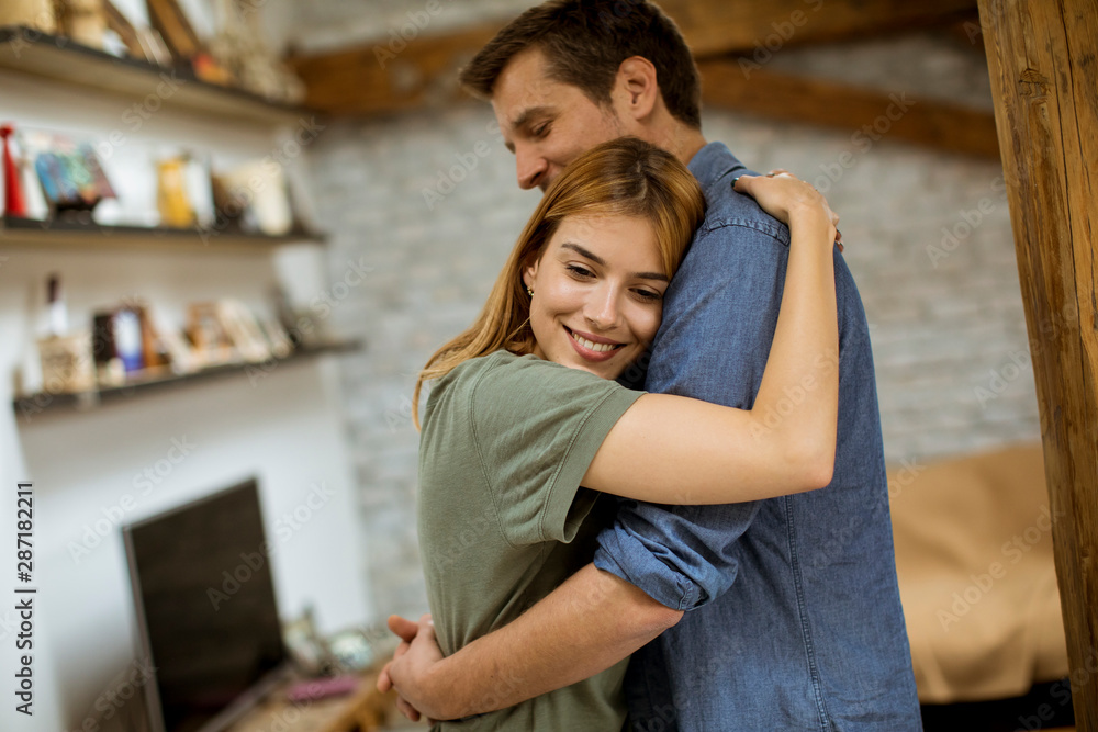 Happy couple hugging in the loft apartment Happy couple hugging in the loft apartment