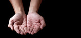 Man hands in praying position low key image. High Contrast