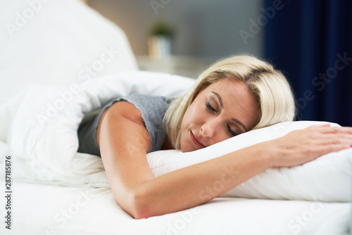 Adult beautiful woman sleeeping inher bed