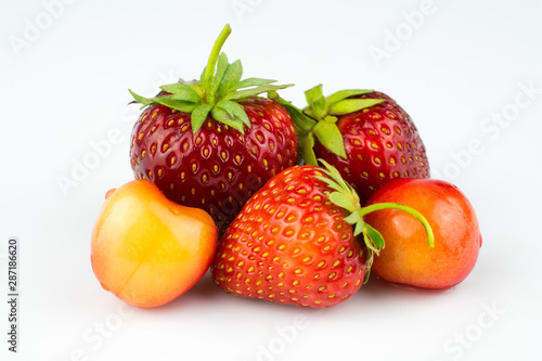 Fresh strawberries and cherries isolated on a white background.