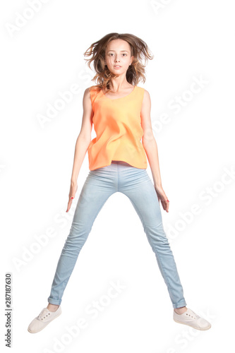 Cute girl in a jump on a white background in the studio.