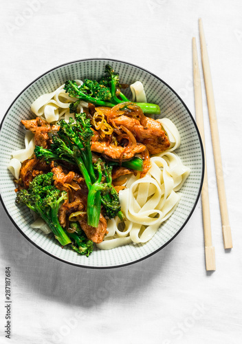 Teriyaki stir fry chicken with broccoli and noodles on light background, top view. Asian style food