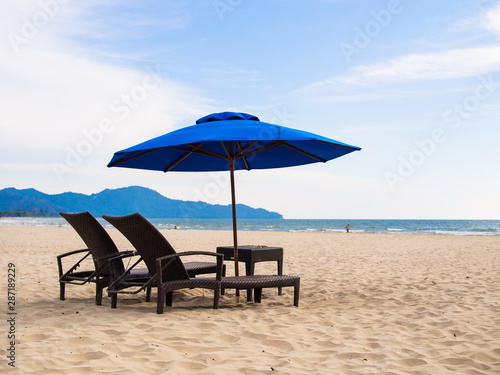 Fototapeta Naklejka Na Ścianę i Meble -  Deck chairs on beach with umbrellaGITAL CAMERA