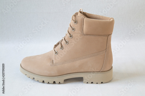 Winter brown leather boots on white background.