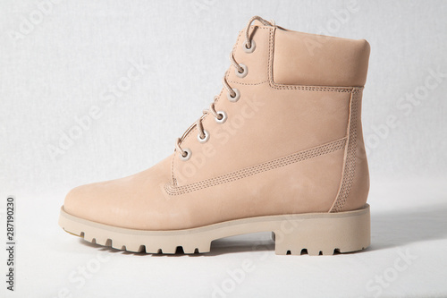 Winter brown leather boots on white background.