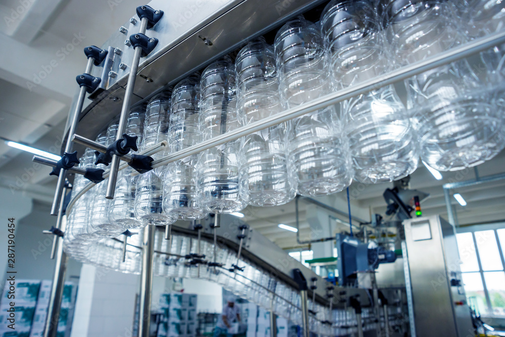 The plastic bottle blowing machine. PET preforms for blowing of plastic bottles. Heating process. The plastic bottle blowing machine. PET preforms for blowing of plastic bottles. Heating process.