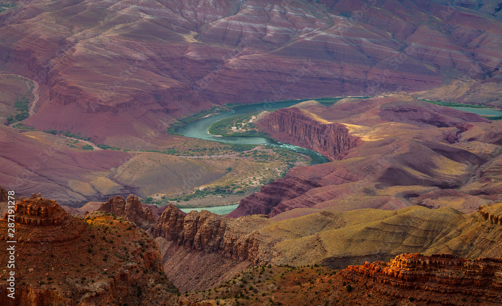 The Colorado River flows through the bottom of the Grand Canyon and can