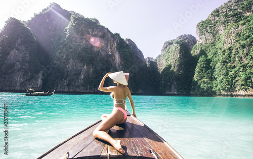 Young woman making a tour on the long tail boat, going to phi phi island © oneinchpunch