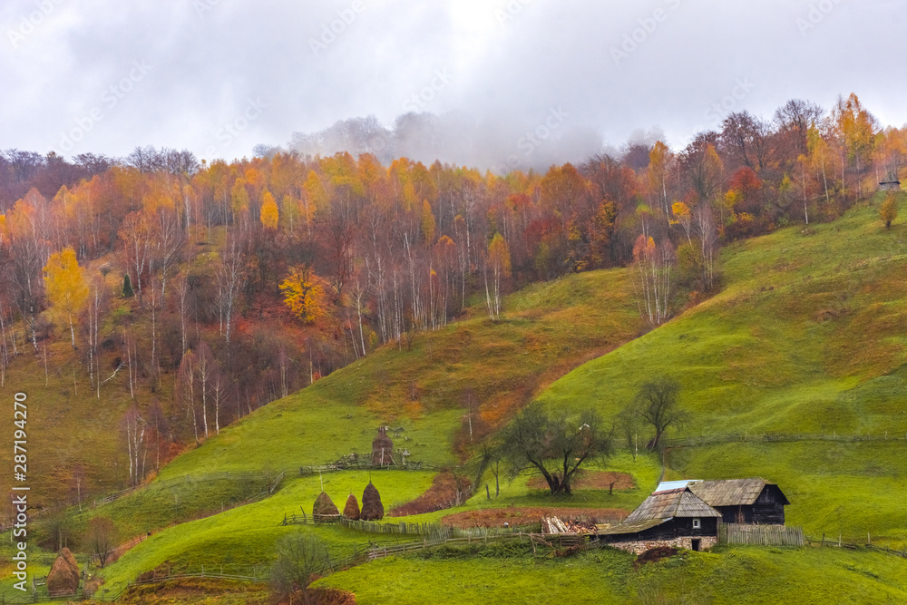 Autumn landscape with traditional houses in Fundatura Ponorului, also known as 