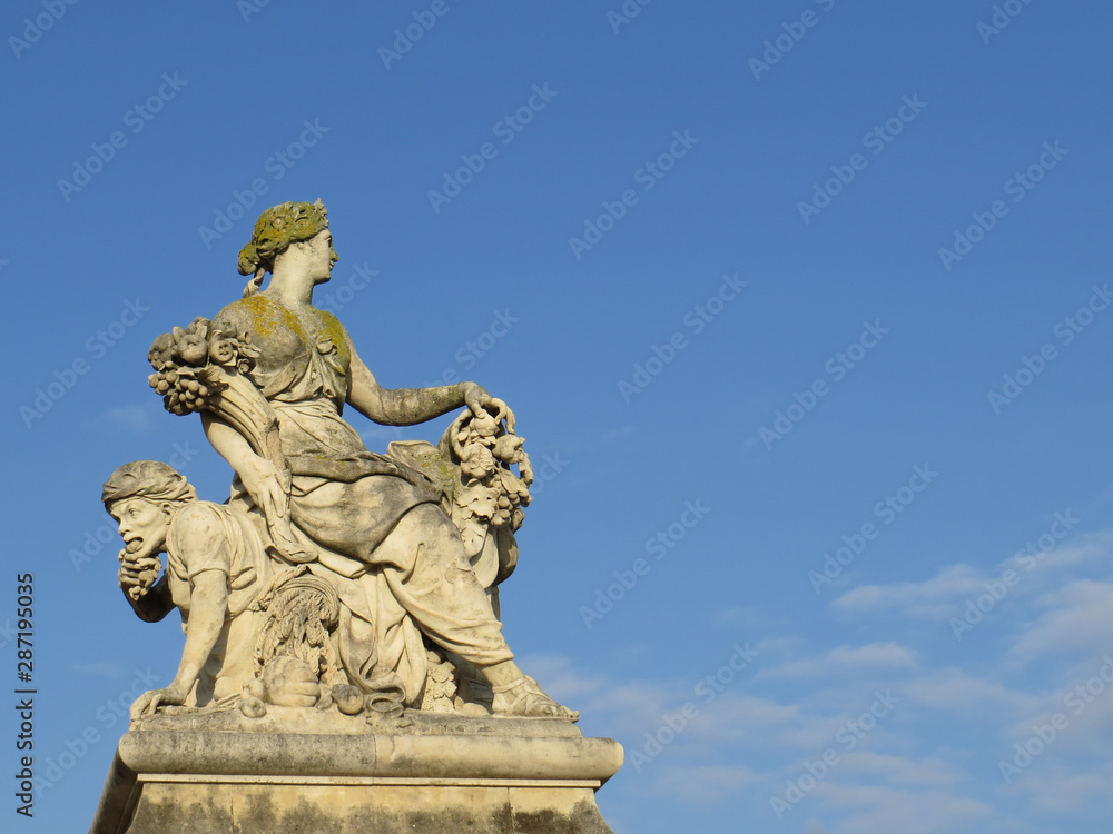 statue with blue sky and clouds