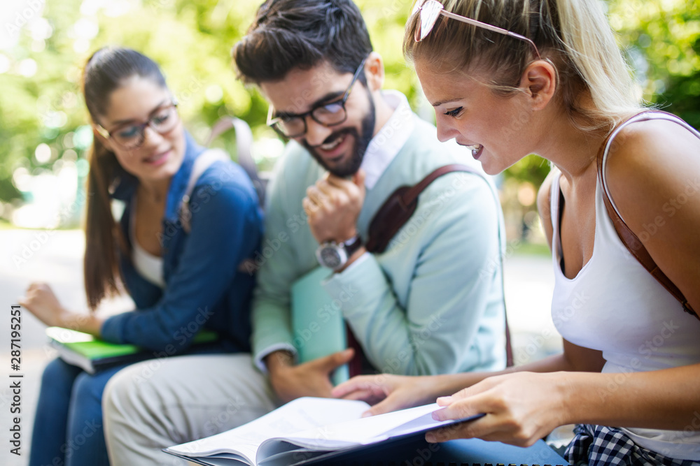 Happy young university students studying together. Group of multiracial friends in college Happy young university students studying together. Group of multiracial friends in college