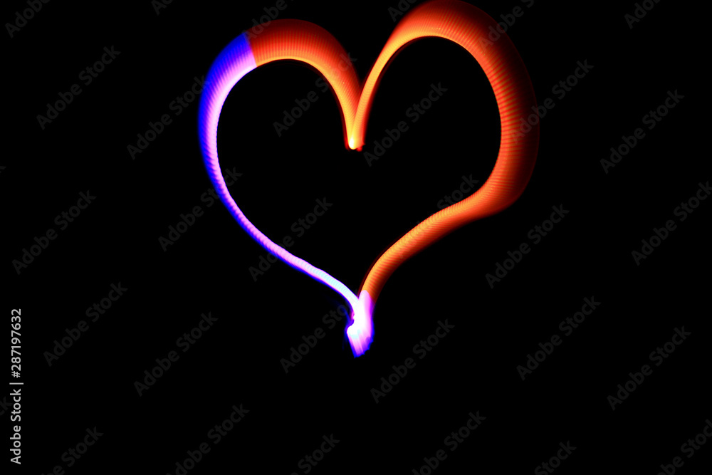 Nice orange and blue heart drawn with a lamp during a lightpainting session at night. Long exposure mode with a camera. Nice orange and blue heart drawn with a lamp during a lightpainting session at night. Long exposure mode with a camera.