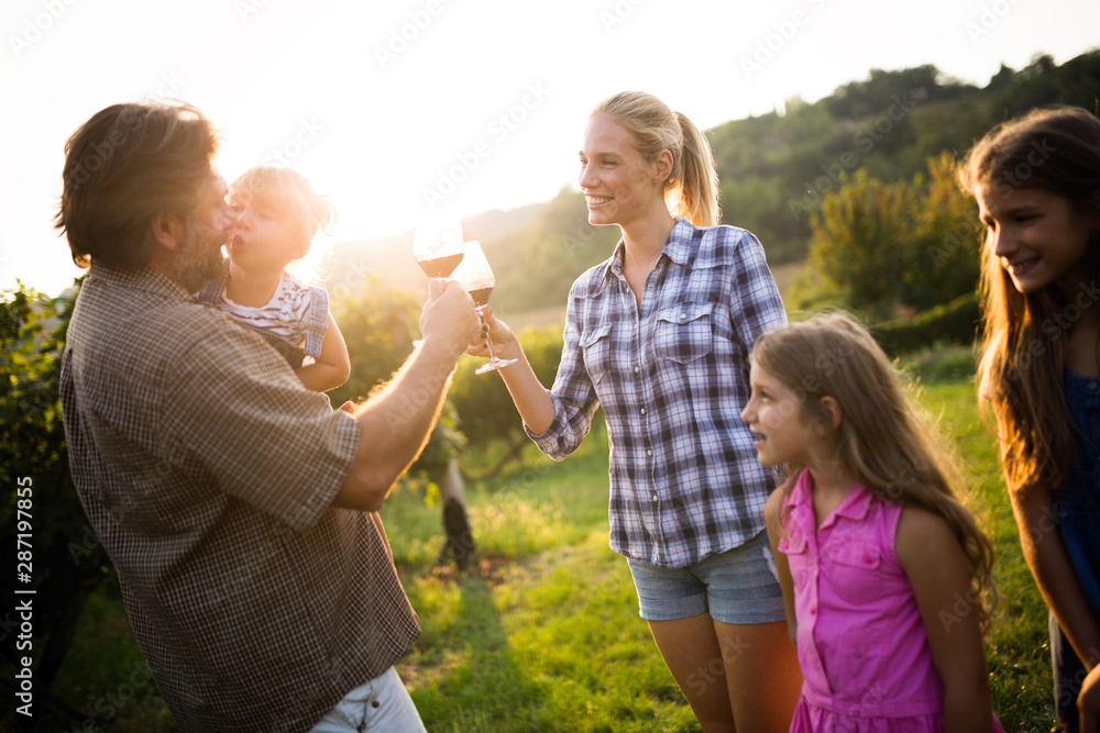 Fototapeta premium Wine growers tasting wine in vineyard nature