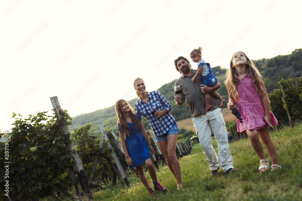 Happy wine grower family walking in vineyard Happy wine grower family walking in vineyard