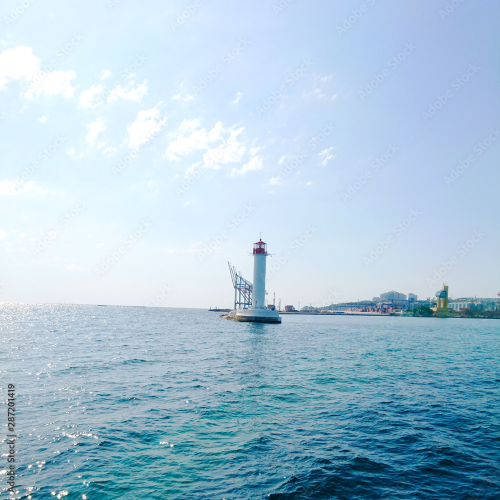 White lighthouse in the sea, view from the boat
