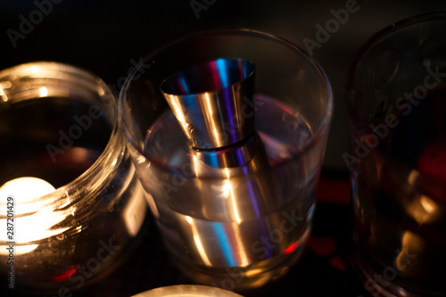 Cup for spirits. Glass at the bar at night in the bar. Metal dishes for vodka and whiskey.