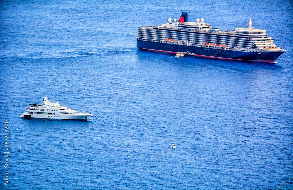 cruise ship in the sea with yacht on the side
