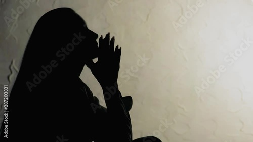 Close up of silhouette unhappy young woman crying
