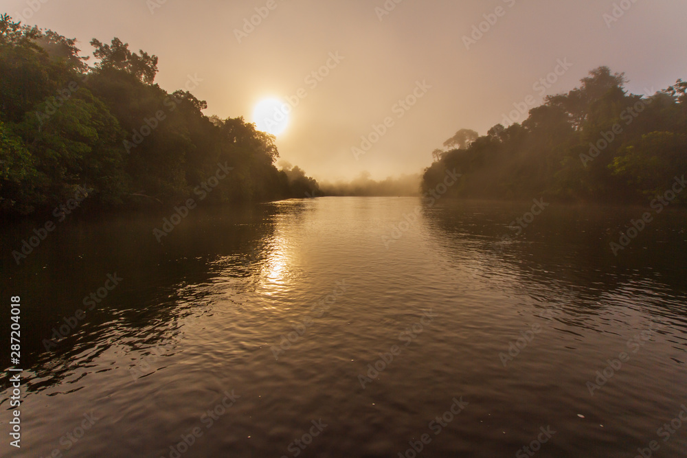 Sunrise with a fog in the cristalino's river, Amazon Rainforest - Mato Grosso, Brazil
