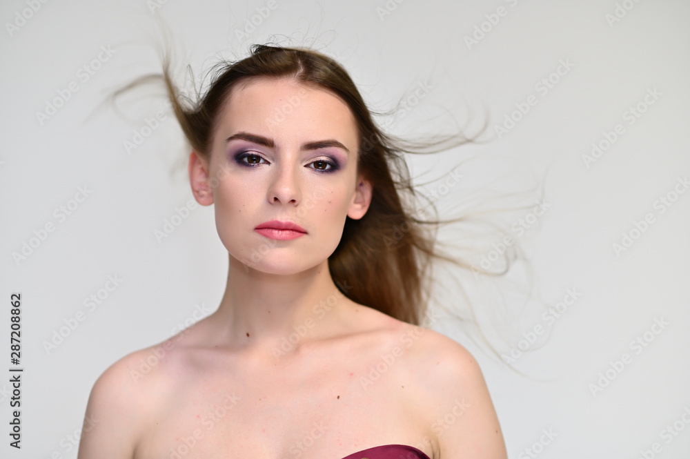 A close-up portrait of a cute girl, a young woman with beautiful curly hair on a white background with excellent face skin and outstanding fashionable make-up. Beauty, brightness. A close-up portrait of a cute girl, a young woman with beautiful curly hair on a white background with excellent face skin and outstanding fashionable make-up. Beauty, brightness.
