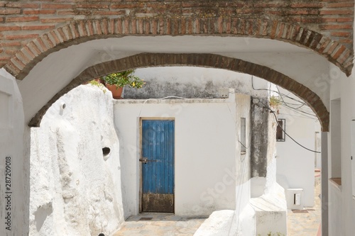 Blue door under arch in Casares, Andalusia, Spain