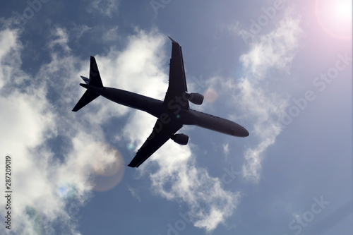 Plane in the blue sky. Holiday and travel concept