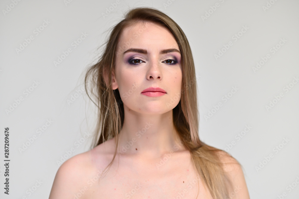 A close-up portrait of a cute girl, a young woman with beautiful curly hair on a white background with excellent face skin and outstanding fashionable make-up. Beauty, brightness. A close-up portrait of a cute girl, a young woman with beautiful curly hair on a white background with excellent face skin and outstanding fashionable make-up. Beauty, brightness.