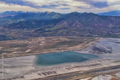 Great Salt Lake Utah Aerial view from airplane looking toward Oquirrh Mountains and Antelope Island, Tooele, Magna, with sweeping cloudscape. United States. photo