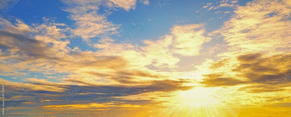 Beautiful Sunset in the sky with sky blue and orange light of the sun through the dark clouds in the sky, Orange and red dramatic colors - Image Beautiful Sunset in the sky with sky blue and orange light of the sun through the dark clouds in the sky, Orange and red dramatic colors - Image