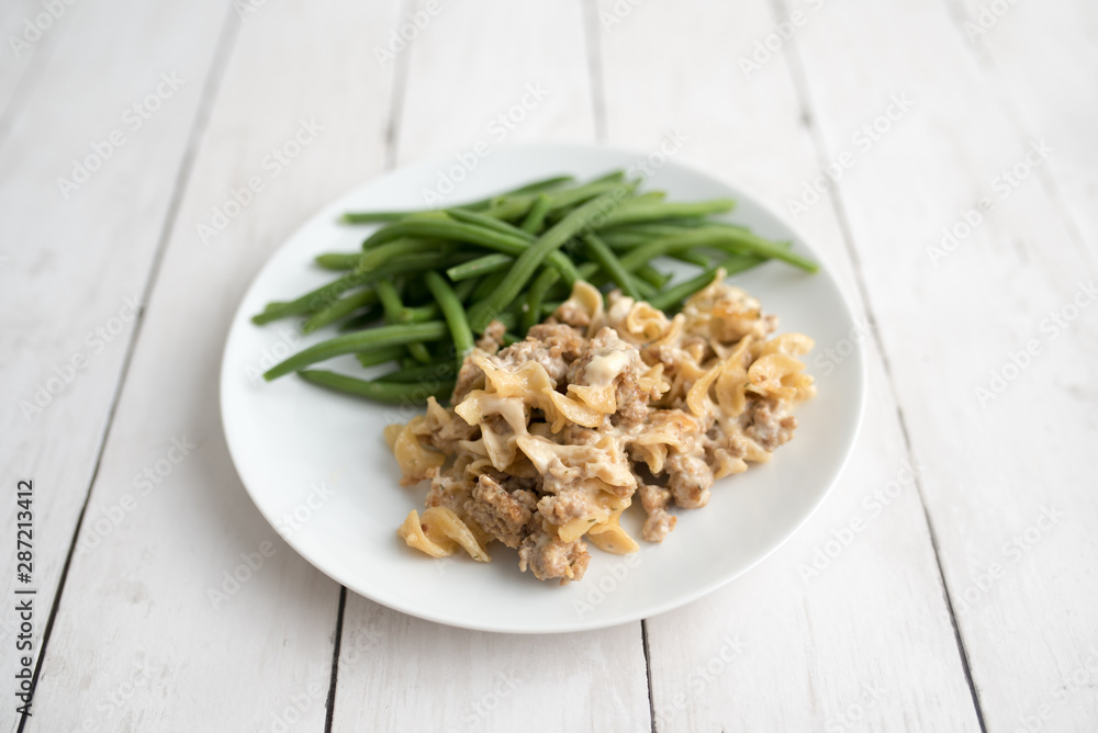 Turkey Stroganoff on white wood table with green beans and seasonings Turkey Stroganoff on white wood table with green beans and seasonings
