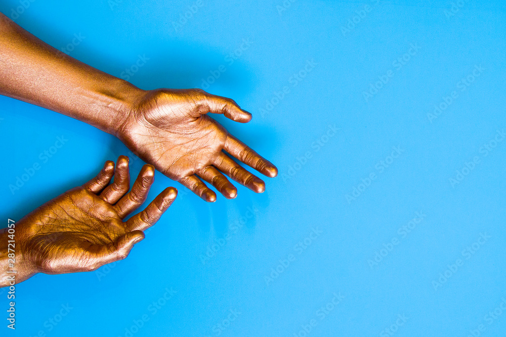 Fototapeta premium Human hands painted in gold color