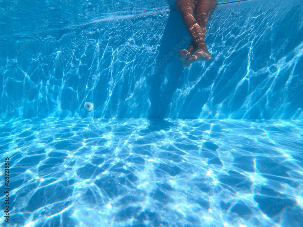 Young Girl Relaxing Her Feet At Swimming Pool underwater view
