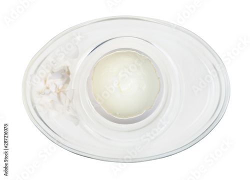 top view of peeled boiled egg in glass egg cup