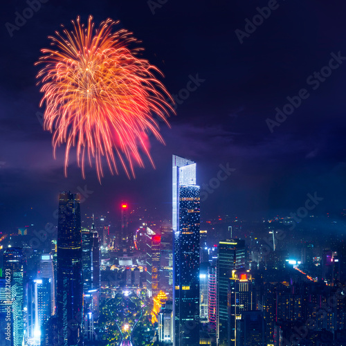 celebration firework with night cityscape of guangzhou urban skyscrapers at storm with lightning  bolts in night purple blue sky  Guangzhou  China