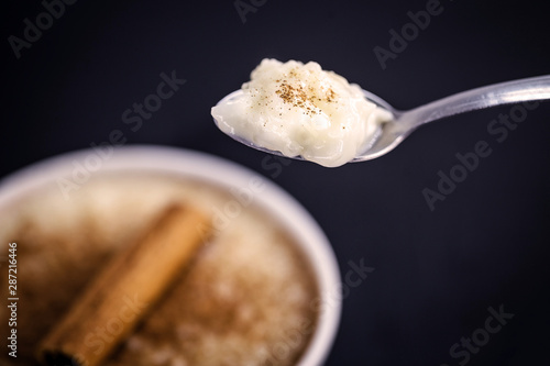 Spoon with rice pudding and cinnamon. Typical dessert from Brazil, a tasty porridge.