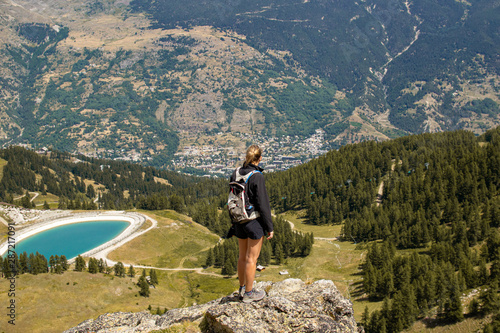 Young Girl in front of an amazing view of a valley in the French mountains