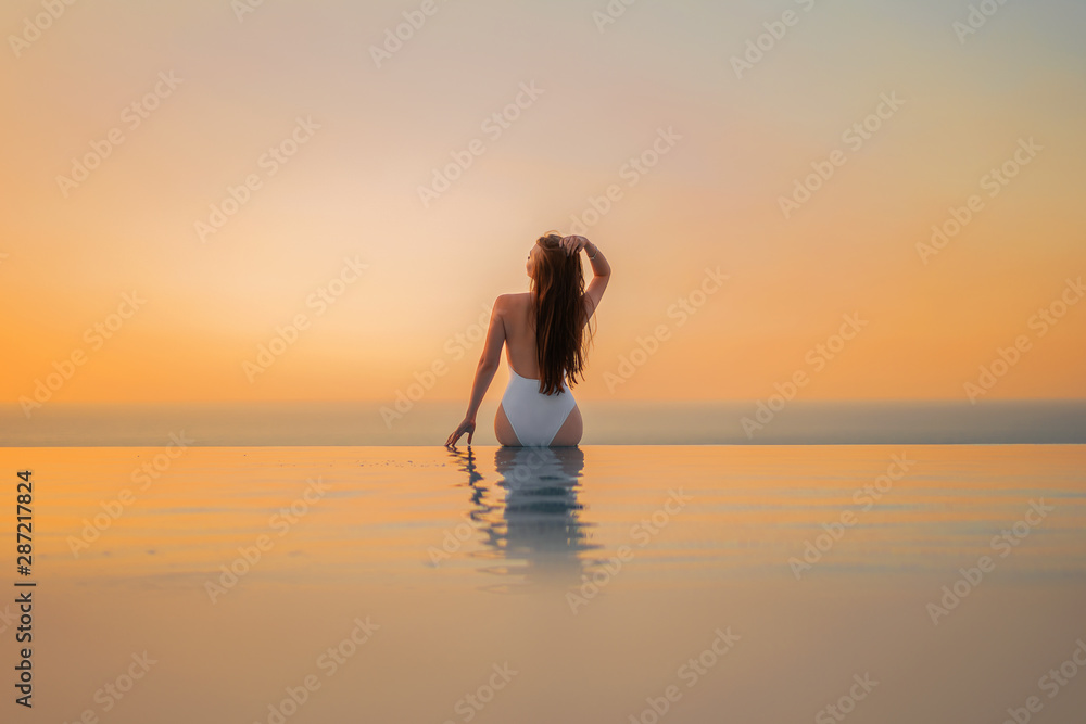Girl at the pool at sunrise