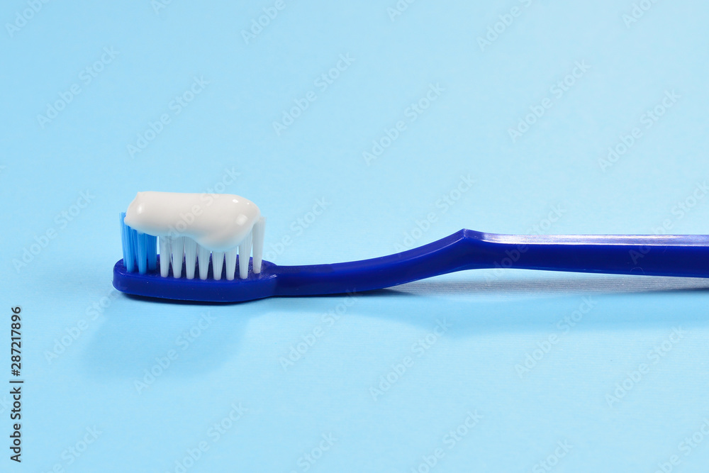 Toothbush with toothpaste on a blue background. Toothbush with toothpaste on a blue background.
