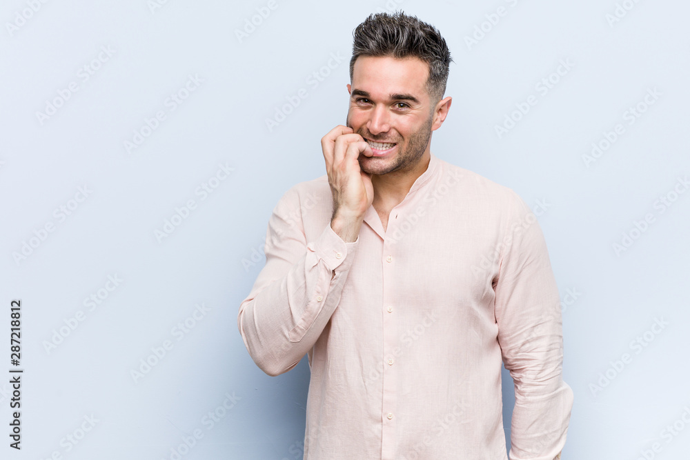 Young handsome cool man biting fingernails, nervous and very anxious. Young handsome cool man biting fingernails, nervous and very anxious.
