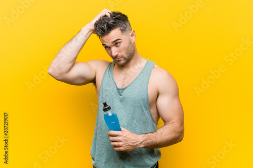 Caucasian man holding an energy drink being shocked, she has remembered important meeting. photo