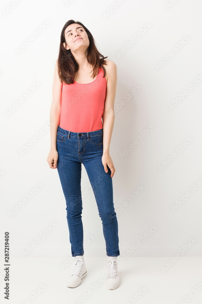 Full body young woman on white background dreaming of achieving goals and purposes Full body young woman on white background dreaming of achieving goals and purposes