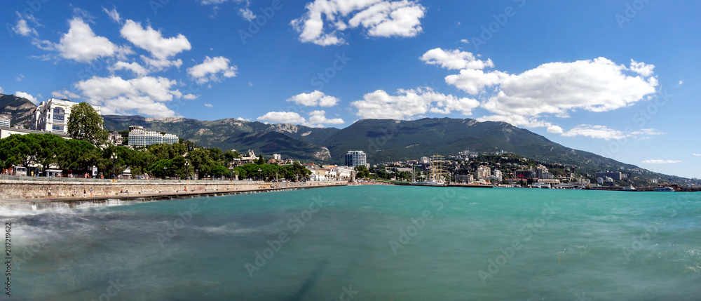 Quay of Yalta on the long exposure on the background mountains and blue sky 2