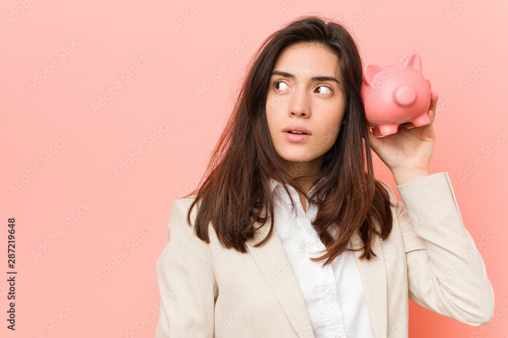 Young caucasian woman holding a piggy bank Young caucasian woman holding a piggy bank