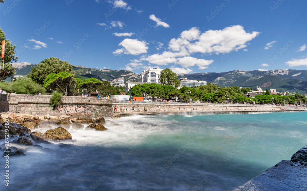 Quay of Yalta on the long exposure on the background mountains and blue sky 3