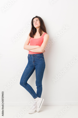 Young caucasian woman standing against a white background
