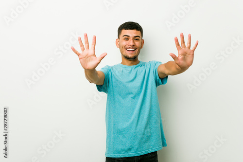 Young hispanic man showing number ten with hands. © Asier