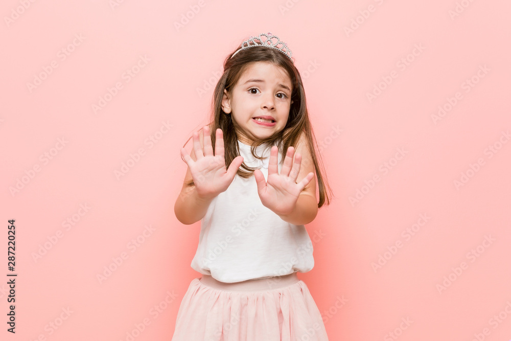 Little girl wearing a princess look rejecting someone showing a gesture of disgust. Little girl wearing a princess look rejecting someone showing a gesture of disgust.