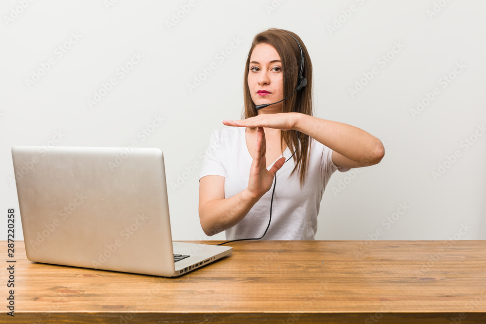 Young telemarketer woman showing a timeout gesture. Young telemarketer woman showing a timeout gesture.