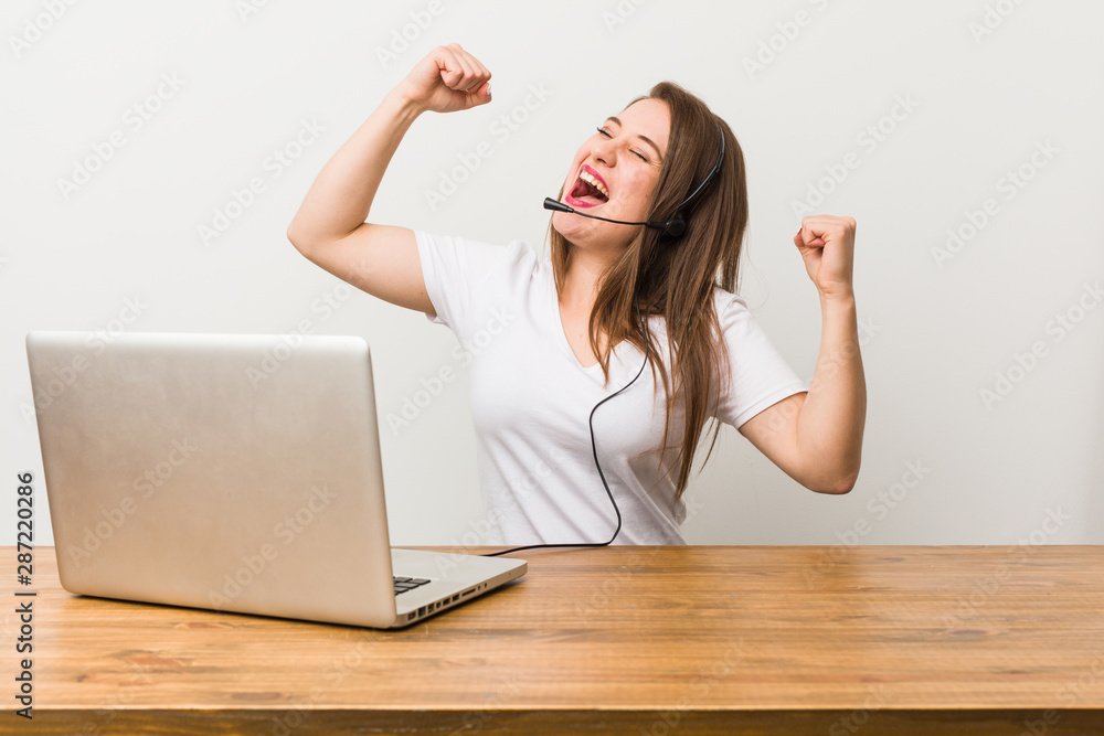 Young telemarketer woman raising fist after a victory, winner concept.